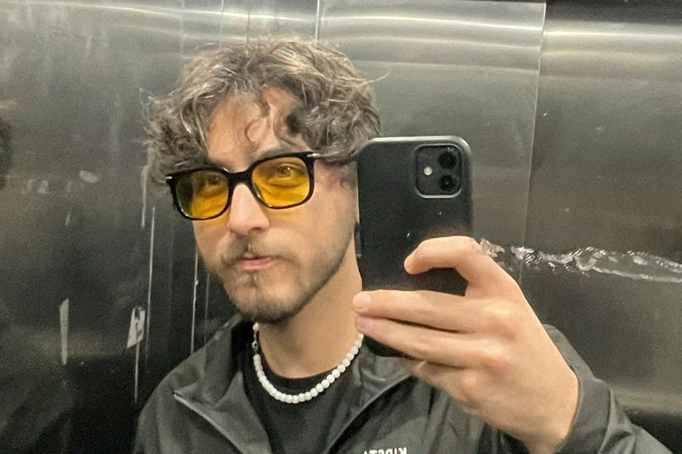 Mirror selfie in yellow glasses, frame 1